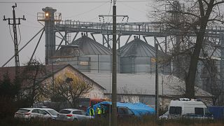 Police officers work outside a grain depot where an explosion killed two people in Przewodow, Poland.