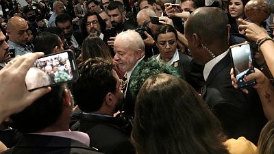 Brazilian President-elect Luiz Inacio Lula da Silva, center, leaves after speaking at COP27. Brazilian President-elect Luiz Inacio Lula da Silva, center, leaves after speaking at COP27.