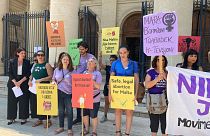 Pro-choice activists stand outside Maltese law courts in Valletta, Malta, Wednesday, 15 June 2022.