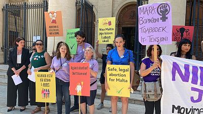 Pro-choice activists stand outside Maltese law courts in Valletta, Malta, Wednesday, 15 June 2022.