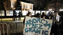 Women's rights activists with a sign reading 'Abortion Without Borders' protesting Poland's strict anti-abortion law in Warsaw in 2022