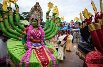 Artists dressed like Hindu deities participate in the Athachamayam procession marking the beginning of Onam festival in Kochi, Kerala.