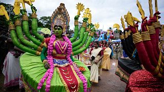 Artists dressed like Hindu deities participate in the Athachamayam procession marking the beginning of Onam festival in Kochi, Kerala.