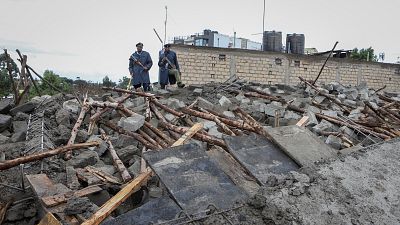 Kenyan police attend the scene of a building collapse in Ruaka, on the outskirts of the capital Nairobi.