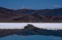 Mountains are reflected in a brine evaporation pond at Albemarle Corp.'s Silver Peak lithium facility, Thursday, Oct. 6, 2022