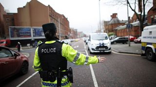 A police officer checks vehicles on the Ormeau Avenue in South Belfast, Northern Ireland,.
