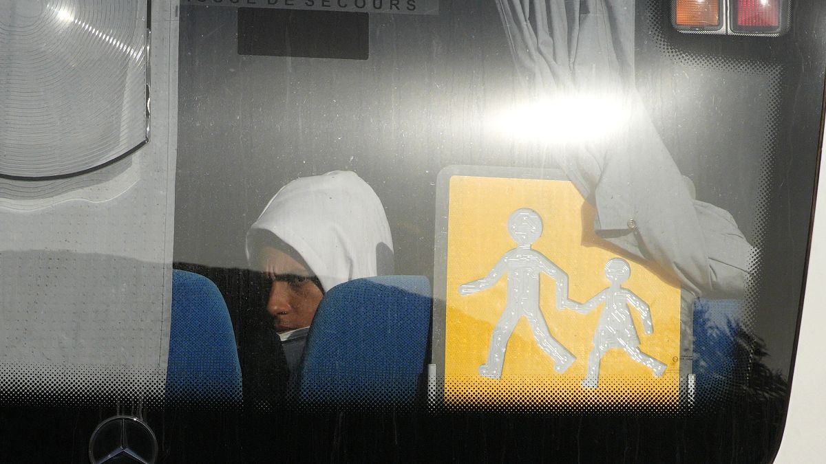 A migrant sits in a coach as he arrives at the holiday camping center in Hyeres, France, Friday 11 November
