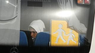 A migrant sits in a coach as he arrives at the holiday camping center in Hyeres, France, Friday 11 November