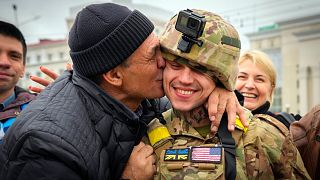 FILE - A Kherson resident kisses a Ukrainian soldier in central Kherson, Ukraine, Sunday, Nov. 13, 2022.