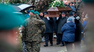 Pallbearers carry the coffin of Boguslaw Wos, one of two Polish men killed in a missile explosion, in Przewodow, Poland, Saturday, Nov. 19, 2022.