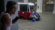 Volunteers helping bus get through floodwaters in Cuba's capital Havana. File photo.
