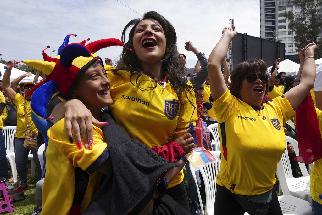 Ecuadorians watch the World Cup inaugural soccer match between Qatar and Ecuador in Quito, Ecuador, Sunday, Nov. 20, 2022.