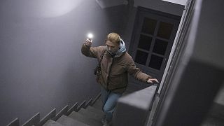Anastasia Pyrozhenko, 25, climbs the stairs in her multi-storey apartment building in Kyiv, 20 November 2022