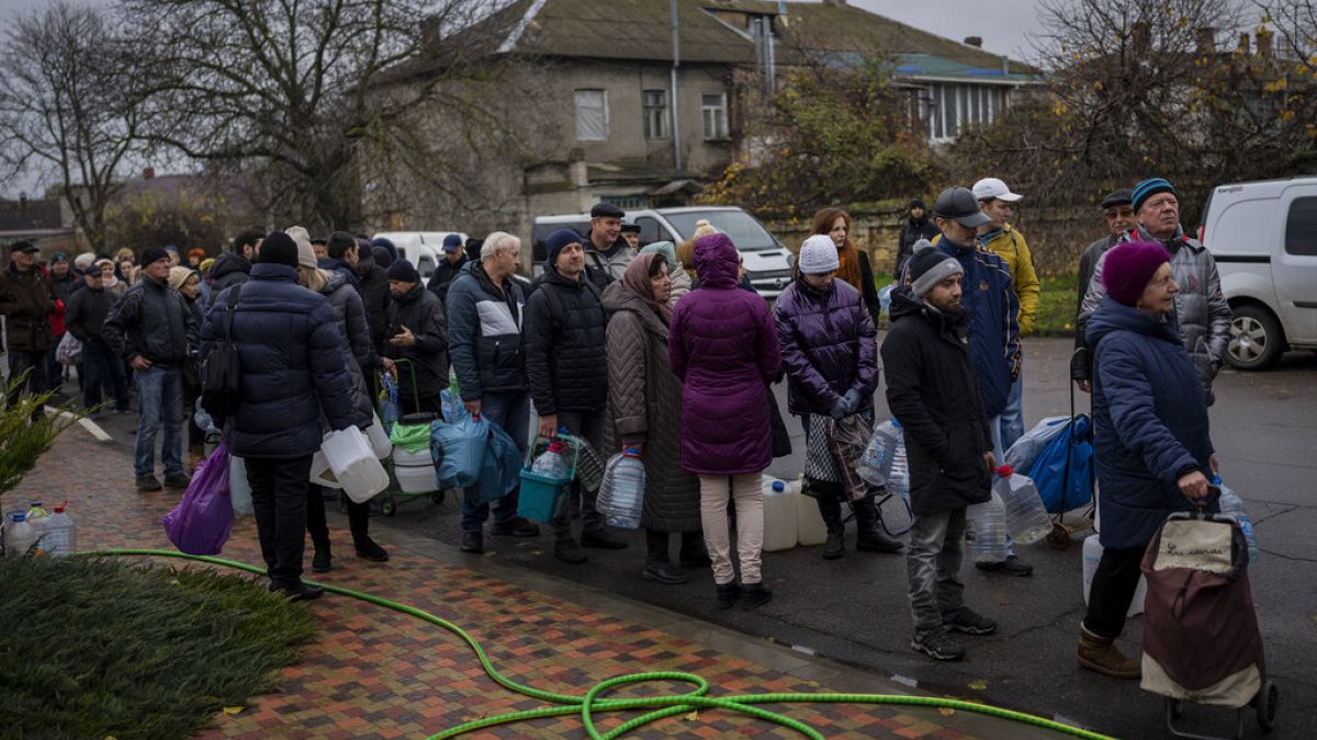 Residents queue to fill containers with drinking water in Kherson, southern Ukraine, Thursday, Nov. 24, 2022. 