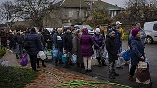 Residents queue to fill containers with drinking water in Kherson, southern Ukraine, Thursday, Nov. 24, 2022.