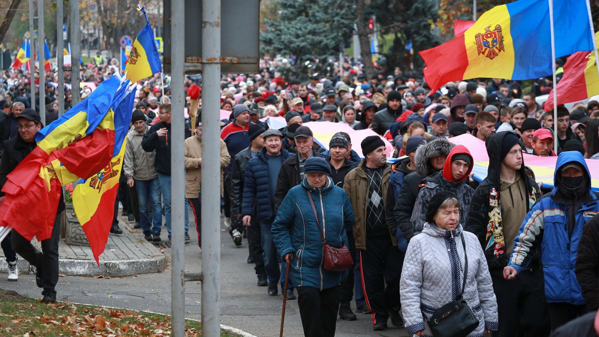 People march during a protest initiated by the populist Shor Party, calling for early elections and President Maia Sandu's resignation, in Chisinau, Moldova.