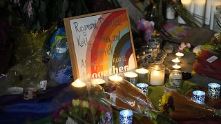 Candles stand near a sign with the names of victims of a weekend mass shooting during a vigil near the gay bar where the attack occurred. Monday, 21 November 2022,