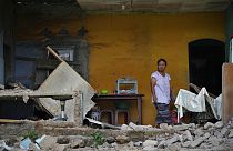 امرأة تقف بجوار حائط من الطوب انهار في منزلها بعد زلزال عنيف ضرب جزيرة جاوا الإندونيسية 