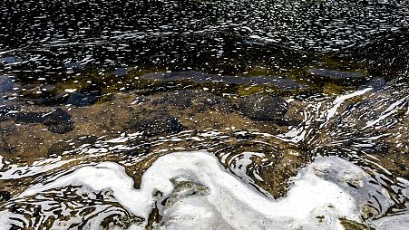 PFAS foam gathers at the the Van Etten Creek dam in Oscoda Township, Mich., near Wurtsmith Air Force Base, US.