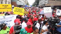 Union members marching in the streets of Pretoria, South Africa to demand higher wages.