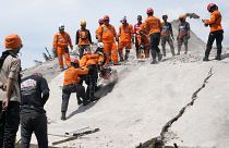 Rescuers cut through the rubble of a collapsed building in Cianjur, West Java
