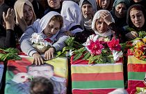 Syrian Kurds attend a funeral of people killed in Turkish airstrikes in the village of Al Malikiyah, northern Syria,