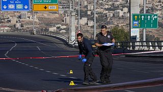 Israeli police inspect the scene of an explosion at a bus stop in Jerusalem, 23 November 2022