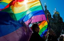 Gay rights activists carry rainbow flags as they march during a May Day rally in St. Petersburg, Russia, Wednesday, May 1, 2013.