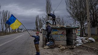 Ukrainian children play at an abandoned checkpoint in Kherson, southern Ukraine, Wednesday, Nov. 23, 2022.