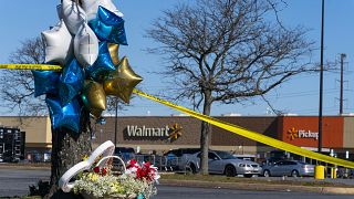 Flowers and balloons have been placed near the scene of a mass shooting at a Walmart in Virginia