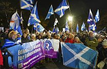 People attend a rally outside the Scottish Parliament