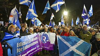 People attend a rally outside the Scottish Parliament