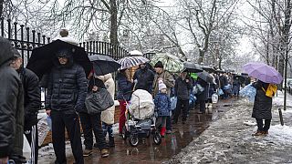 People line up to collect water, in Kyiv, Ukraine, Thursday, Nov. 24, 2022.