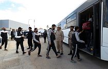 Migrants boarded buses before returning to their home countries