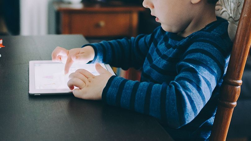 A child plays with a smart tablet