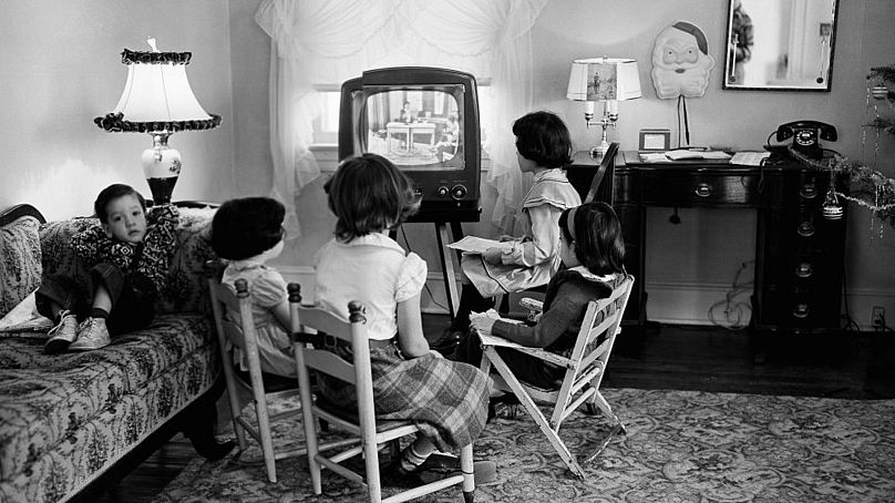 In this Jan. 6, 1953, file photo, school children watch a teacher giving them a lesson via television at home in Baltimore