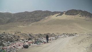 Industrial waste litters the sand in the Atacama Desert