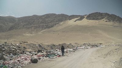 Industrial waste litters the sand in the Atacama Desert