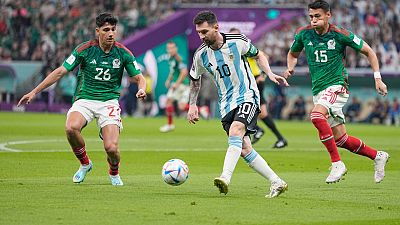 Argentina's Lionel Messi, center, tries to dribbles past Mexico's Kevin Alvarez, left, and Mexico's Hector Moreno in Doha, Qatar, Saturday, Nov. 26, 2022.