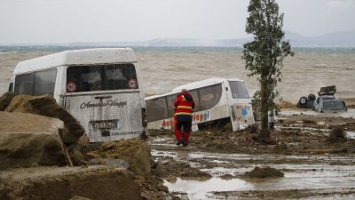 A rescuer near vehicles carried away after heavy rain triggered landslides that collapsed buildings and left up to 12 people missing, in Casamicciola, Ischia, Nov. 26, 2022.