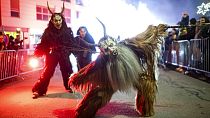 A participant wearing a traditional Krampus costume and a mask performs during a Krampus run in Hollabrunn, Austria, Sunday, Nov. 26, 2022. 