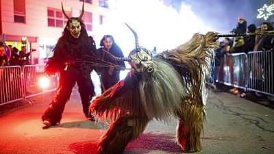 A participant wearing a traditional Krampus costume and a mask performs during a Krampus run in Hollabrunn, Austria, Sunday, Nov. 26, 2022.