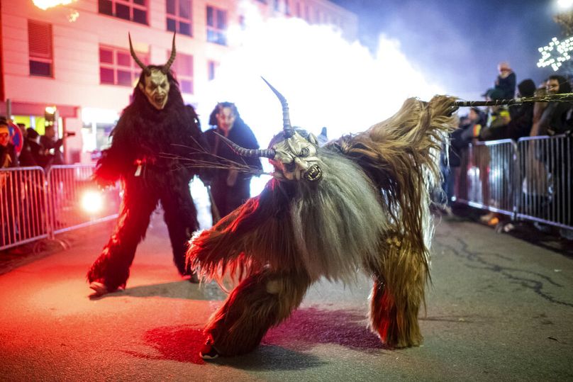 A participant wearing a traditional Krampus costume and a mask performs during a Krampus run in Hollabrunn, November 2022