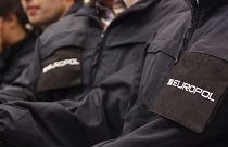 Operatives wearing uniforms with the logo of Europol