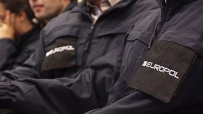 Operatives wearing uniforms with the logo of Europol