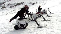 Testers mount the new French-made 'moonbike', an all-eclectric snowbike. 