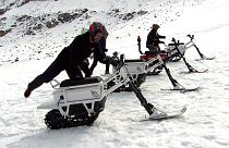 Testers mount the new French-made 'moonbike', an all-eclectric snowbike. 