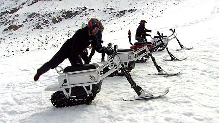 Testers mount the new French-made 'moonbike', an all-eclectric snowbike.