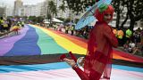 A person poses for a photo during the 27th Gay Pride Parade along Copacabana beach in Rio de Janeiro, Brazil.
