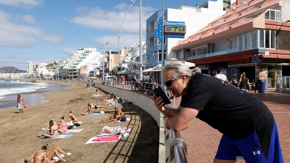 50-year-old Russian Victor Varlamov talks on his phone from Las Canteras Beach Avenue in Las Palmas de Gran Canaria.